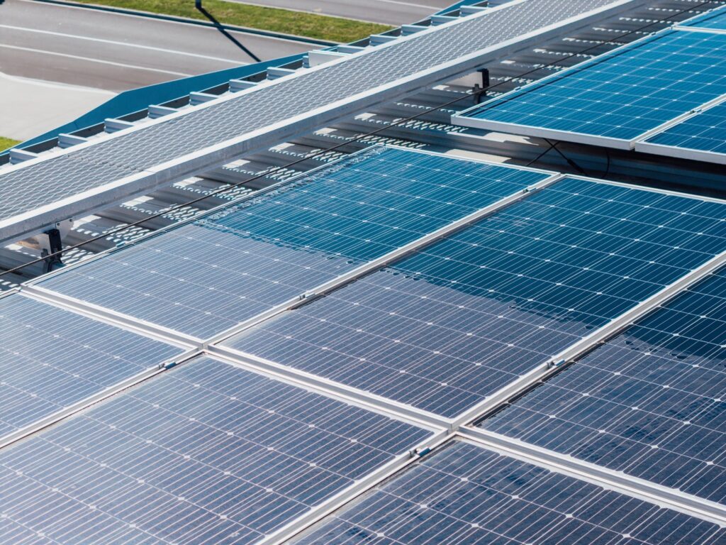 Commercial solar panels half cleaned, showing the difference pure water cleaning makes