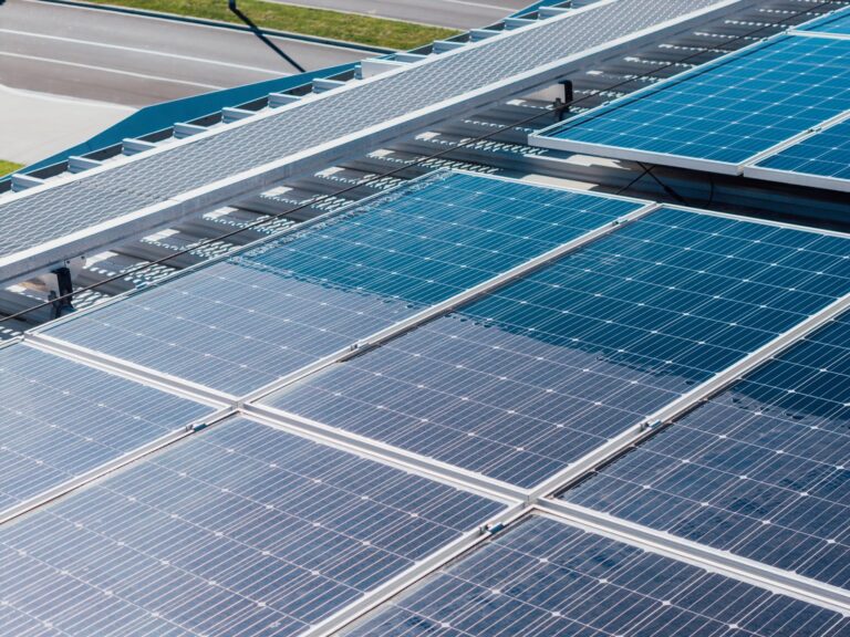 Commercial solar panels half cleaned, showing the difference pure water cleaning makes