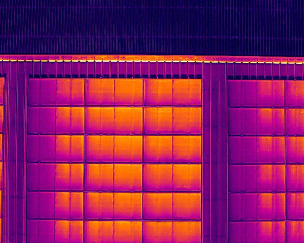 Thermal image showing heat signatures across solar panels during a drone inspection