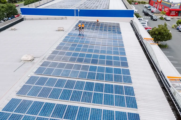 Aerial view of a commercial rooftop solar array being cleaned