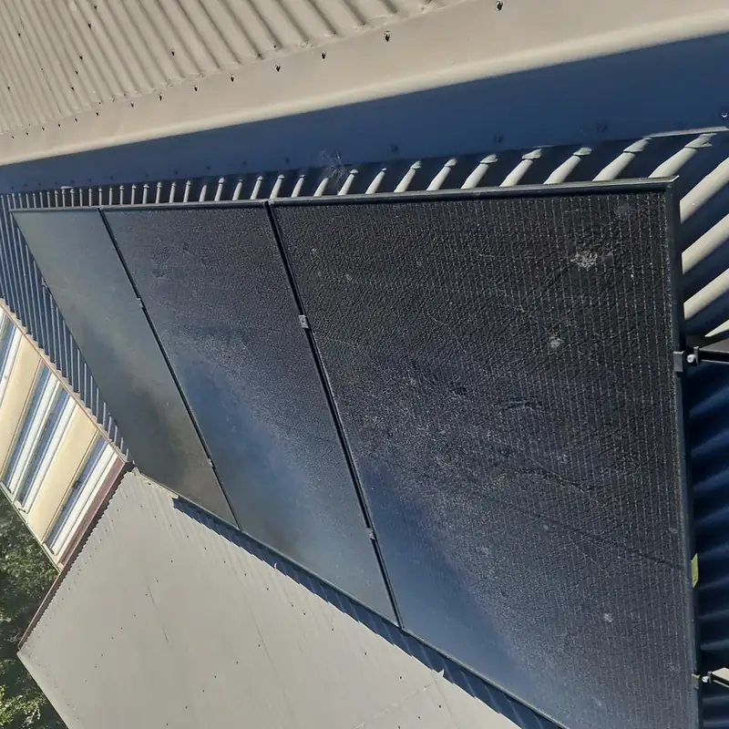 Solar panels in Puketapu before cleaning: dust and grime along the roofline