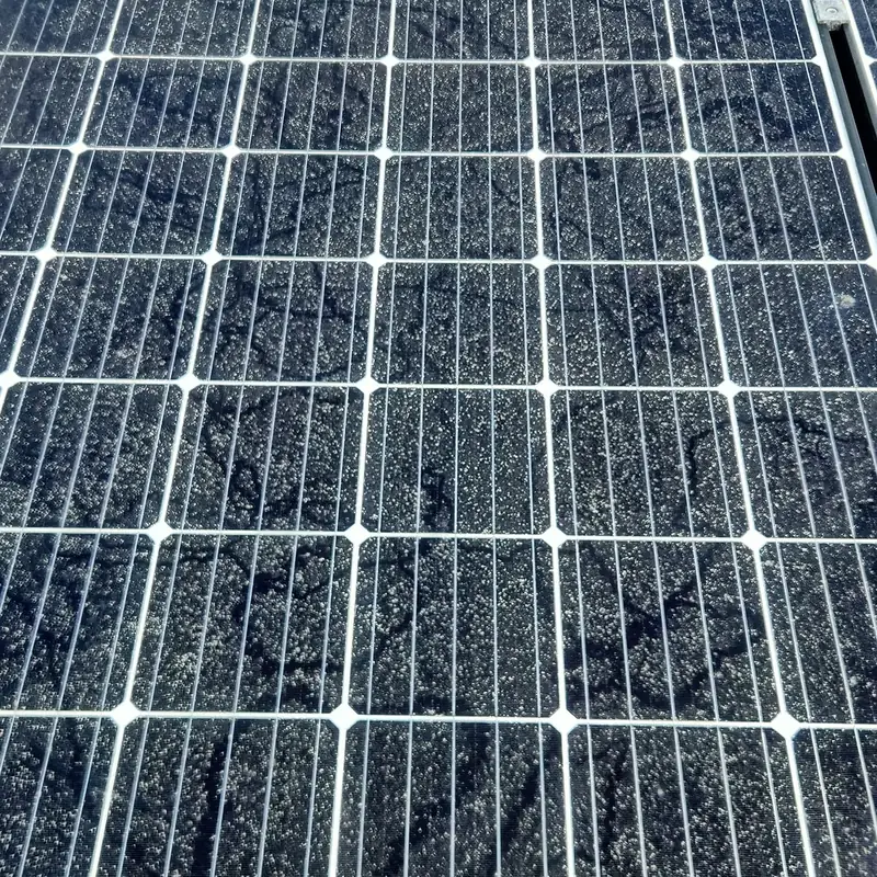Solar panels in Whatawhata before cleaning: a heavy layer of dust and grime