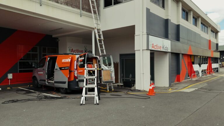 Eco Shine Solar van and ladders set up at a commercial solar job